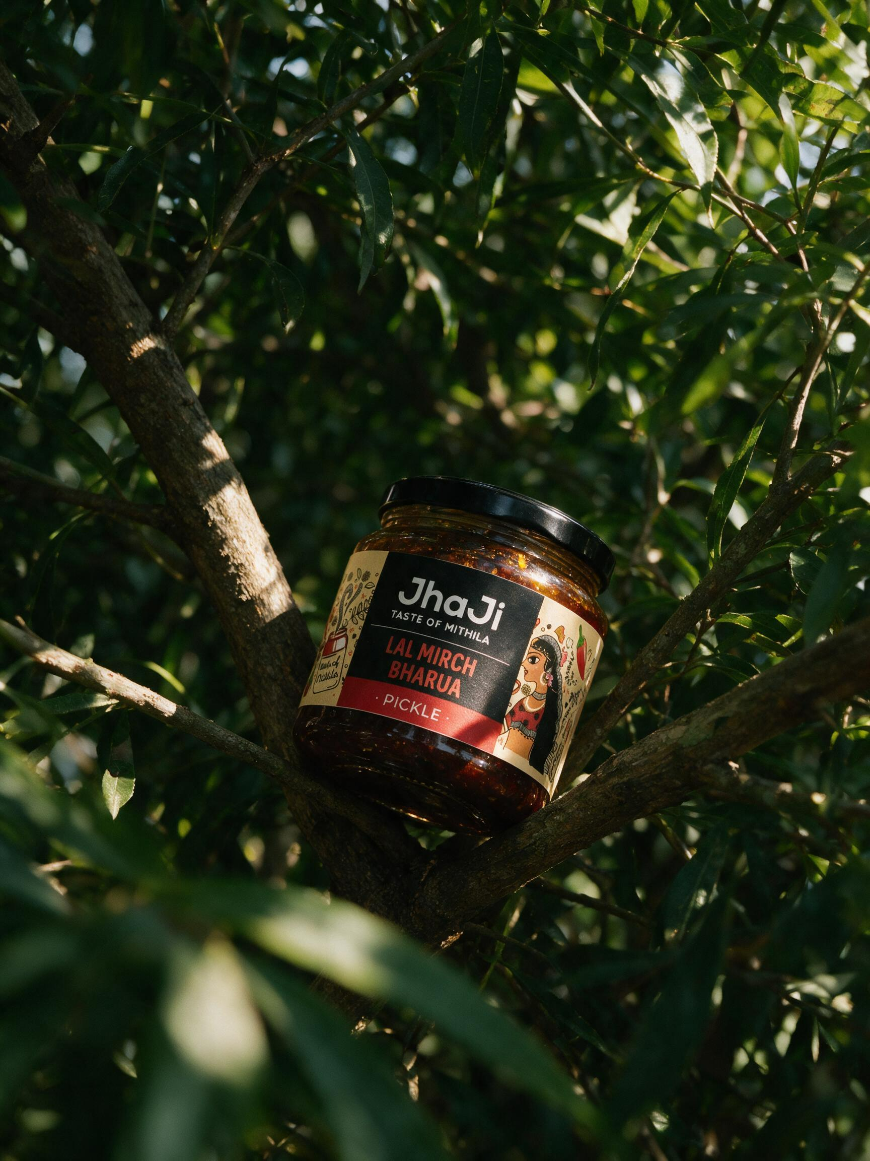 Product jar resting naturally between green tree branches in dappled sunlight